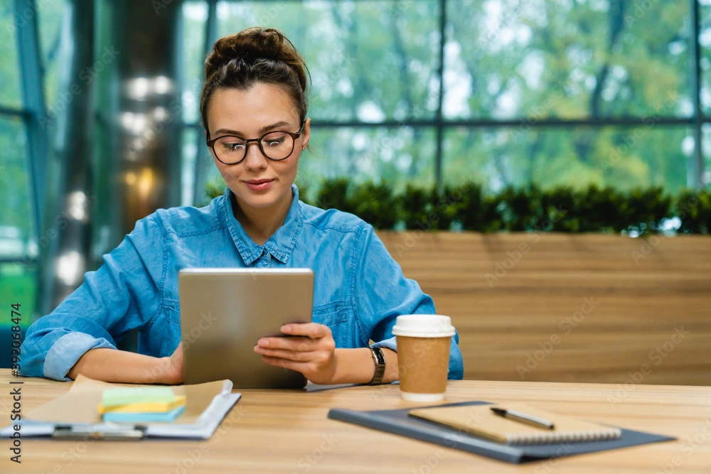 Woman using tablet at a desk