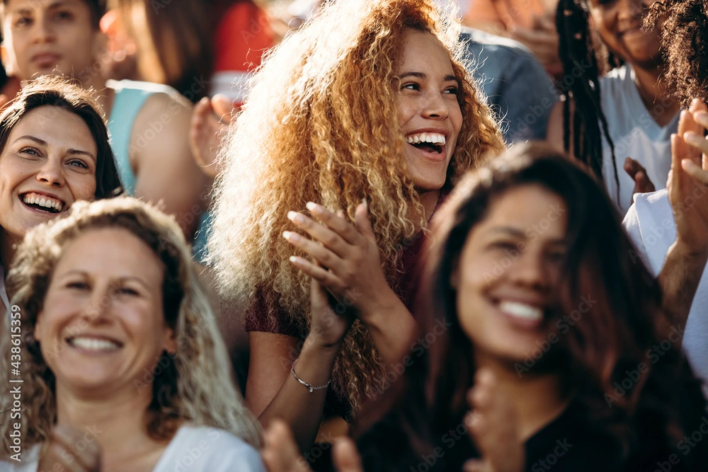 Happy crowd clapping at event